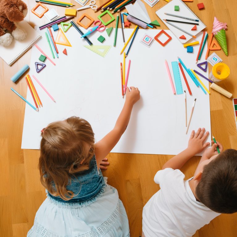 Two-year-olds at Lighthouse Academy engage in music and art activities to enhance cognitive and motor skills.